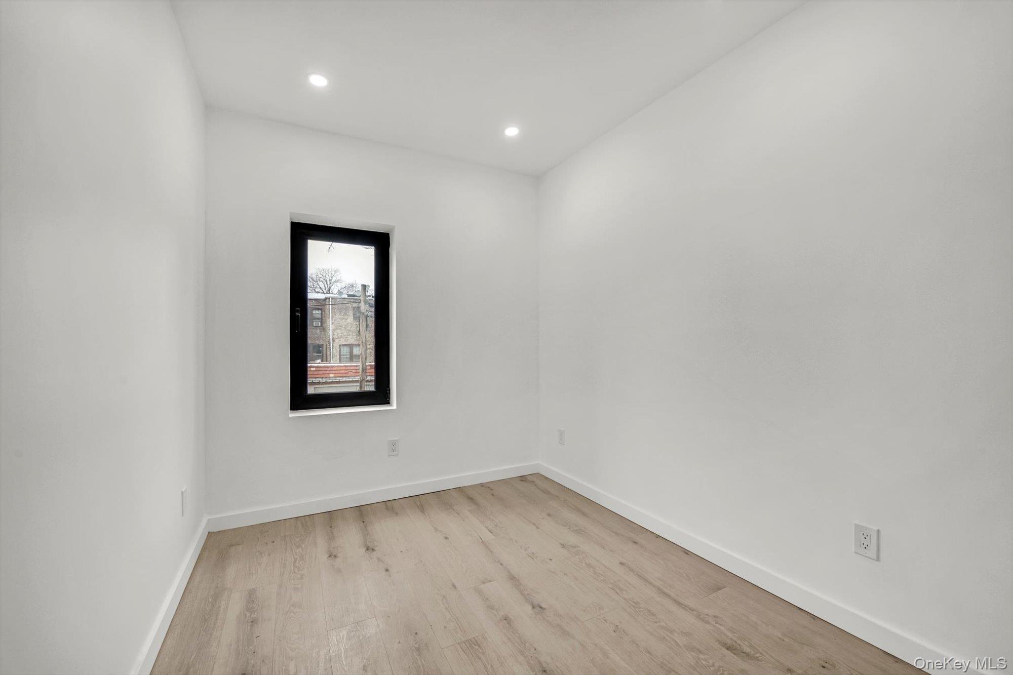 85-45 67th Road Queens, NY 11374 - Photo 20 of 28 an empty room with a window