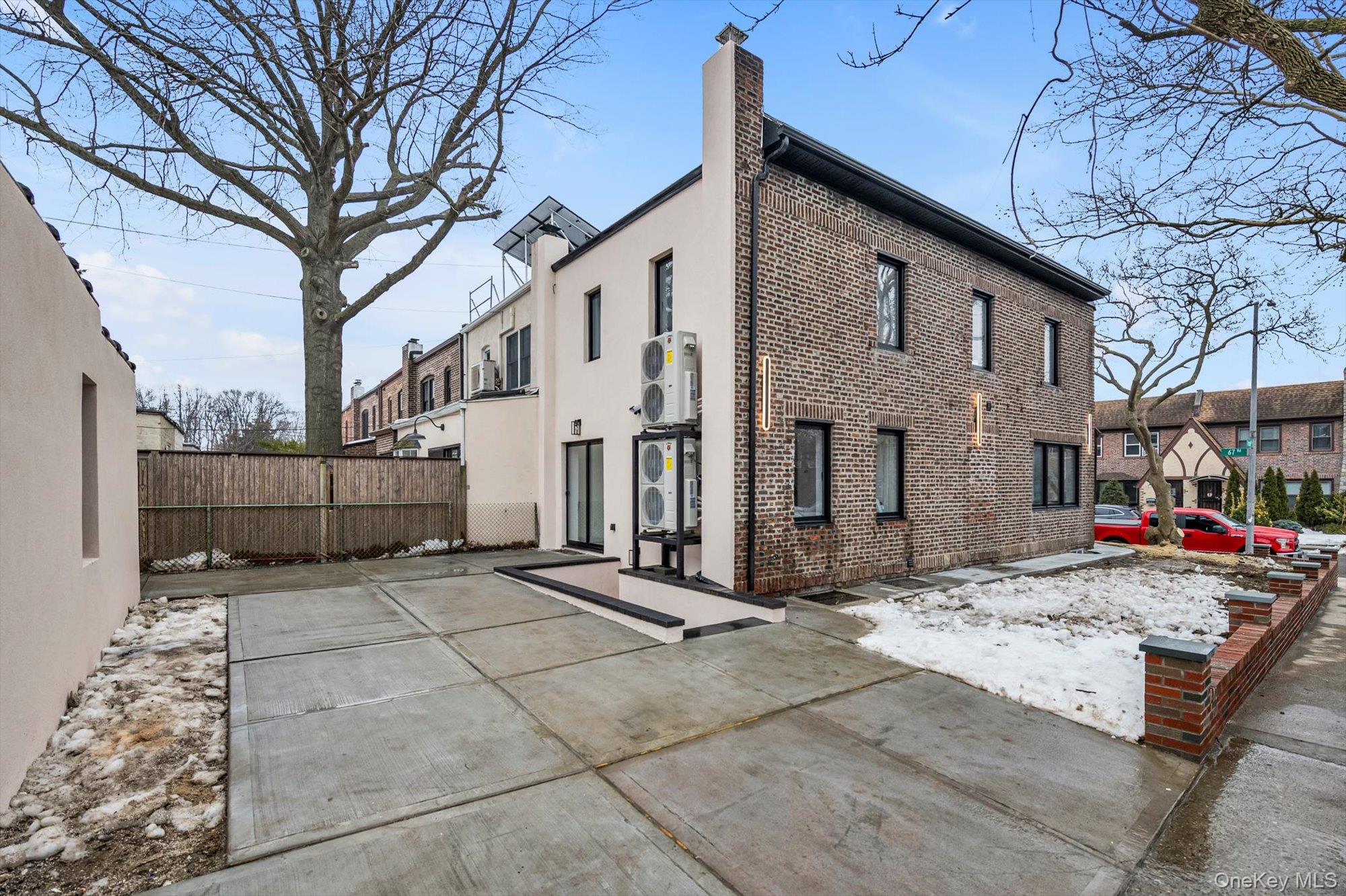 85-45 67th Road Queens, NY 11374 - Photo 25 of 28 a view of a white house with a large tree