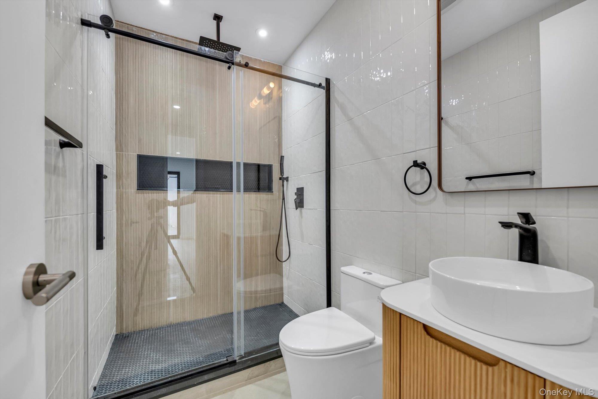 85-45 67th Road Queens, NY 11374 - Photo 8 of 28 a bathroom with a sink a toilet and shower