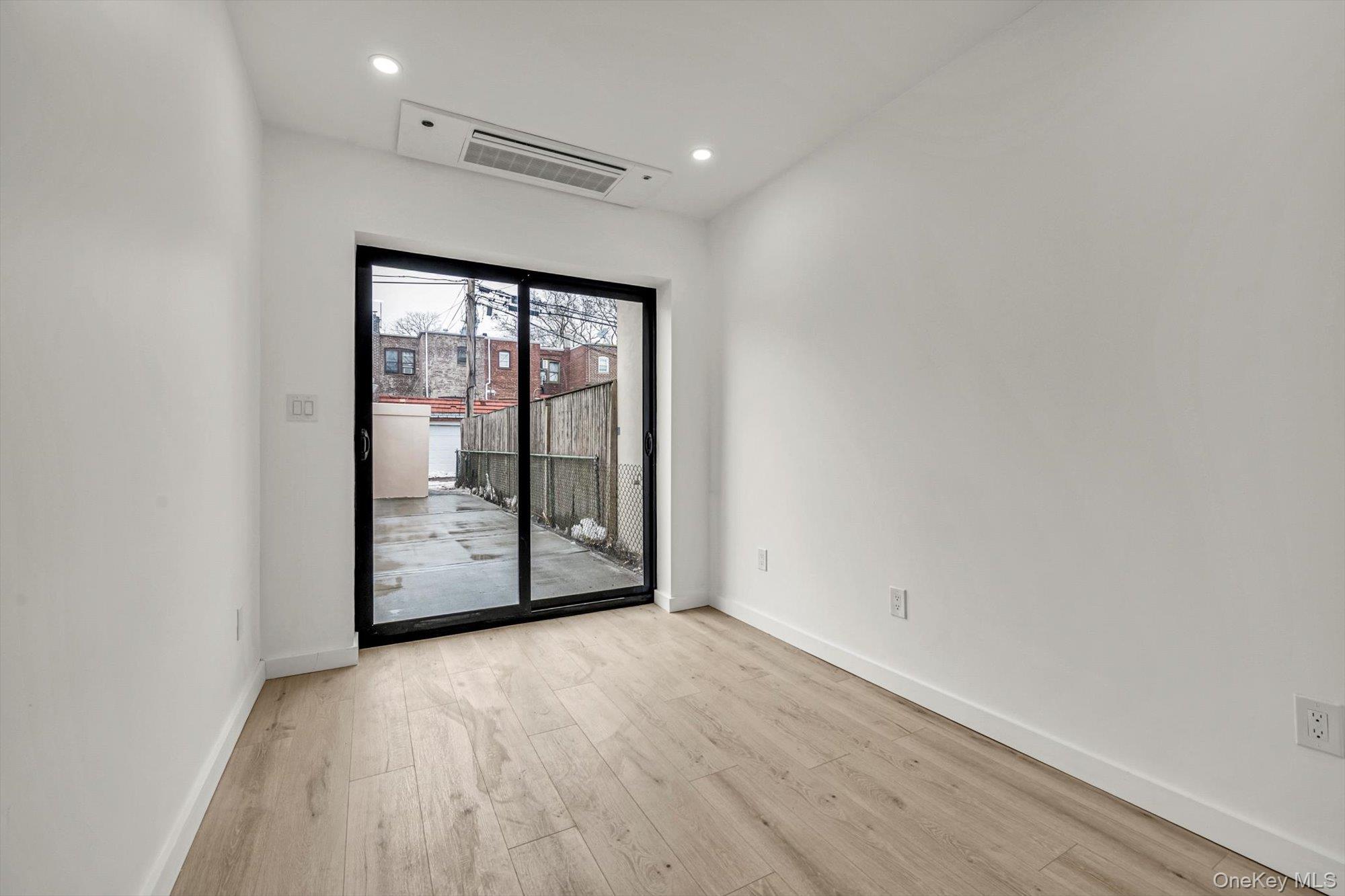 85-45 67th Road Queens, NY 11374 - Photo 9 of 28 a view of an empty room with glass door