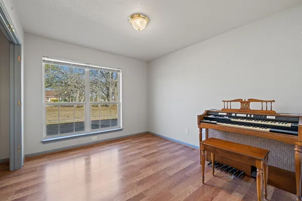 a view of a workspace with furniture and a window