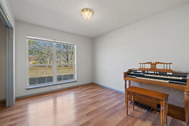 a view of a workspace with furniture and a window