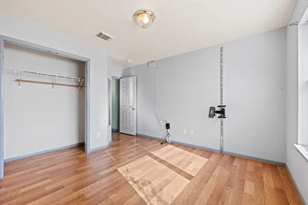a view of a room with wooden floor