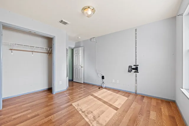 a view of a room with wooden floor