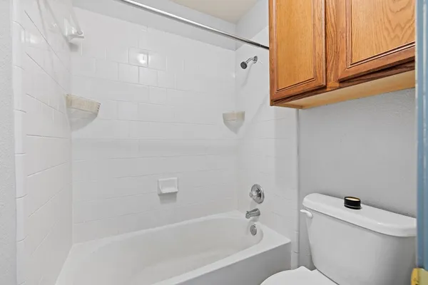 a bathroom with a bathtub and toilet