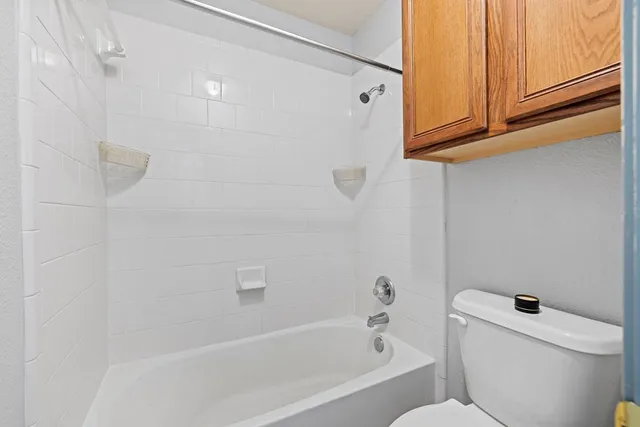 a bathroom with a bathtub and toilet