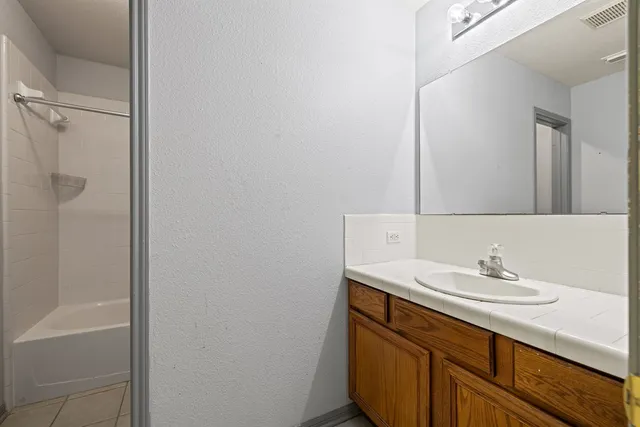 a bathroom with a sink a mirror and a shower