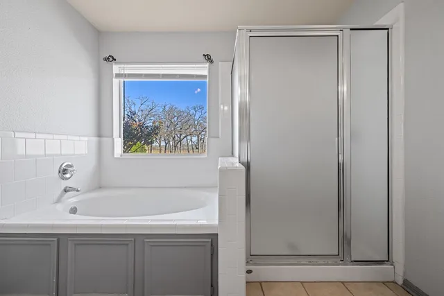 a bathroom with a bathtub and a shower