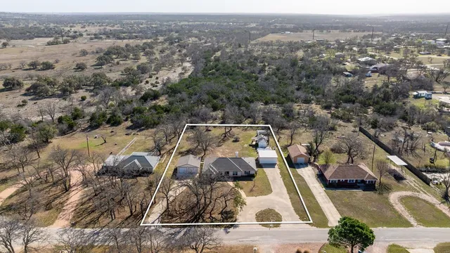 an aerial view of a house with a swimming pool