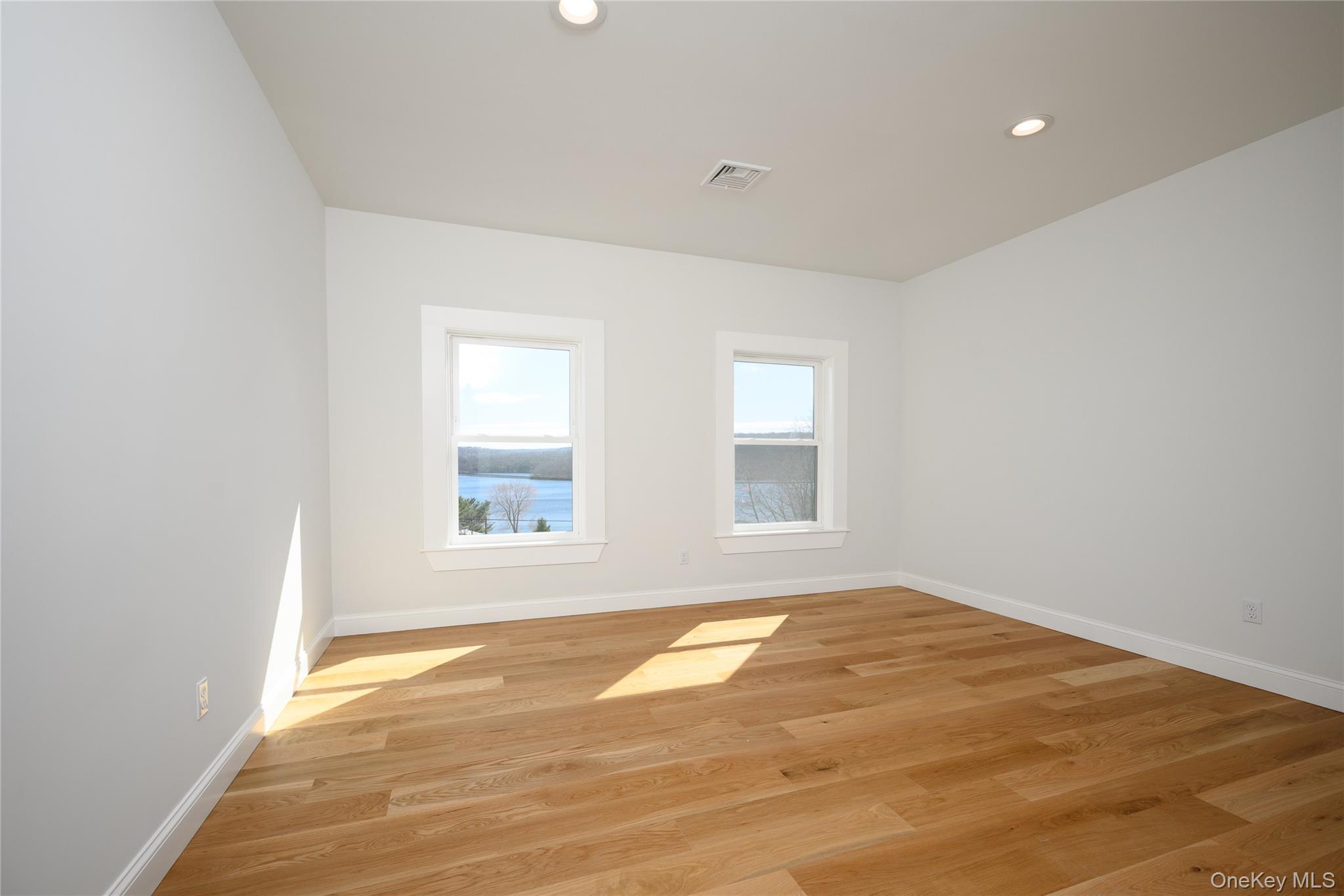133 West Mombasha Road Monroe, NY 10950 - Photo 42 of 47 an empty room with wooden floor and windows