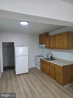 a kitchen with a sink cabinets and stainless steel appliances