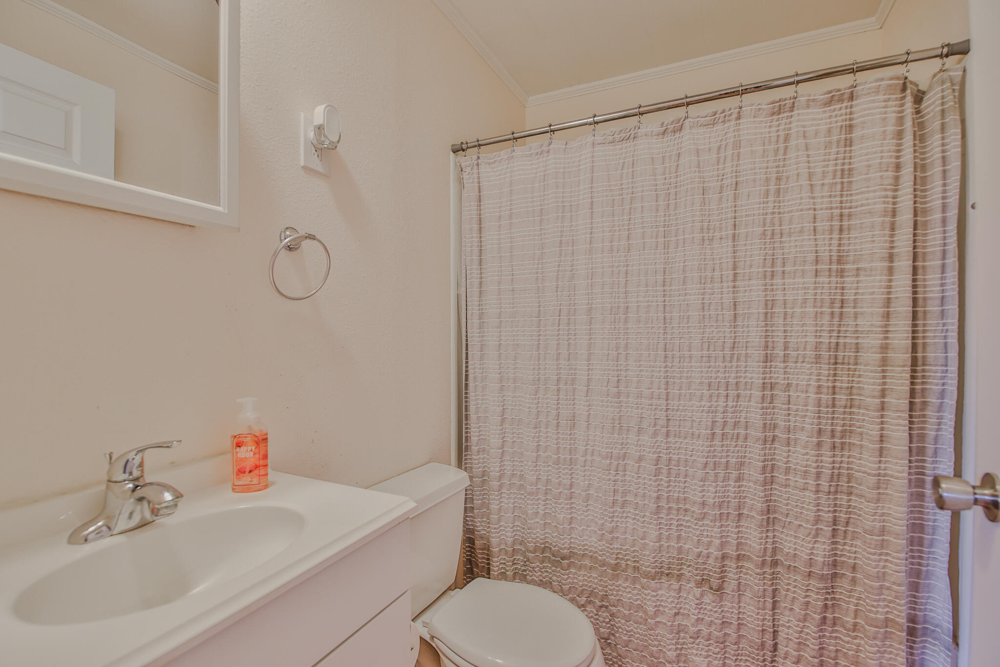805 South 4th Street Slaton, TX 79364 - Photo 11 of 28 a bathroom with a sink a toilet and shower curtain