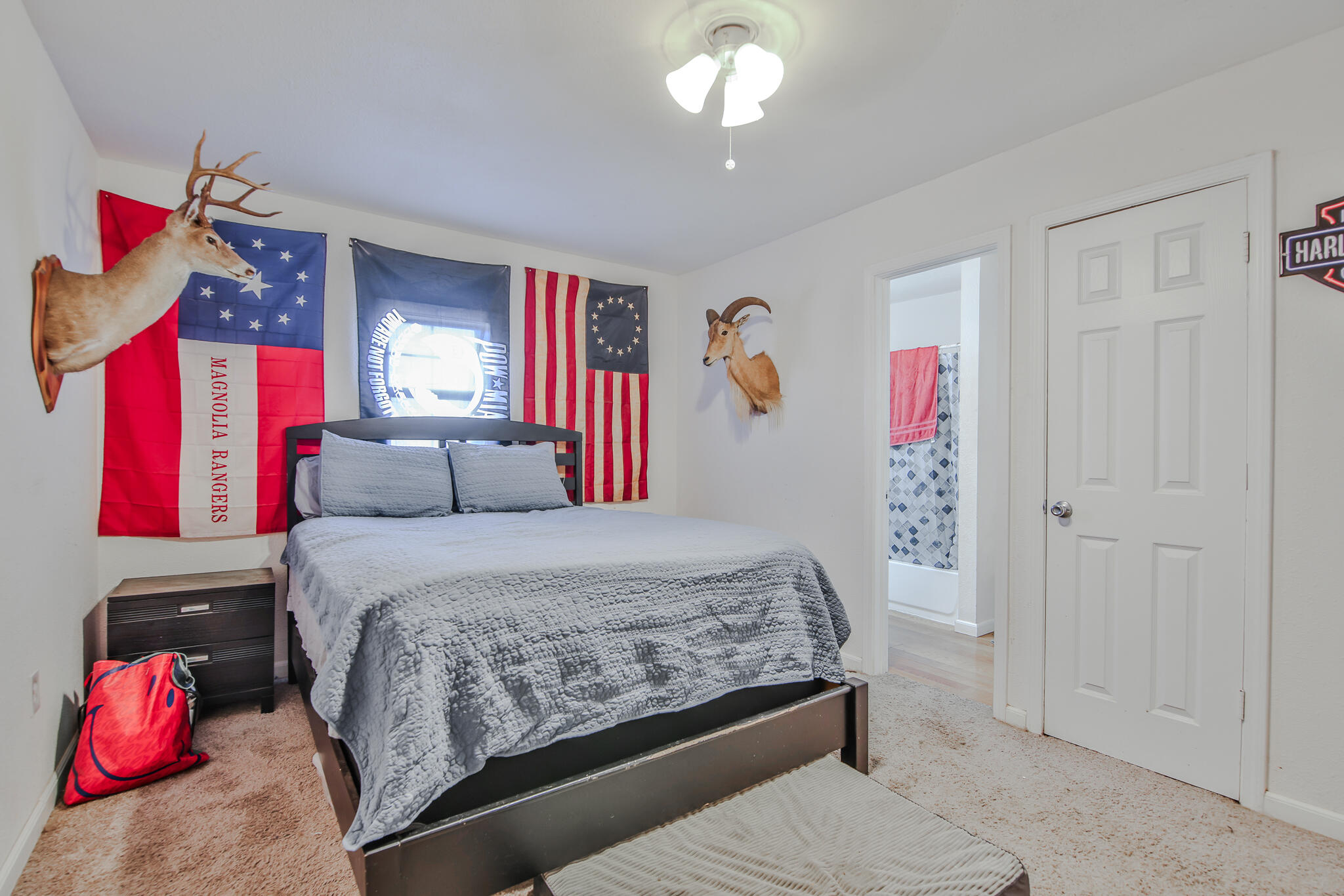 805 South 4th Street Slaton, TX 79364 - Photo 21 of 28 a bedroom with a bed and a chandelier
