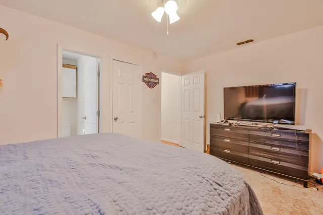 a bedroom with a bed and a flat screen tv