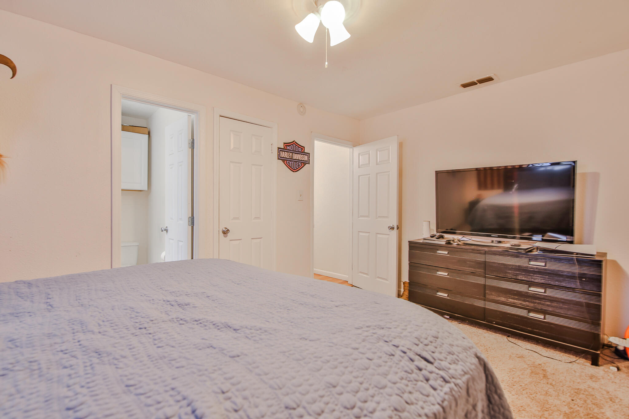 805 South 4th Street Slaton, TX 79364 - Photo 22 of 28 a bedroom with a bed and a flat screen tv