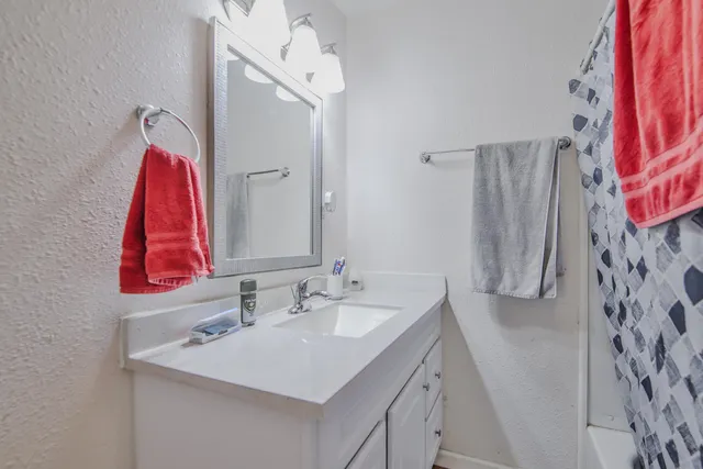 a bathroom with a sink vanity and a mirror