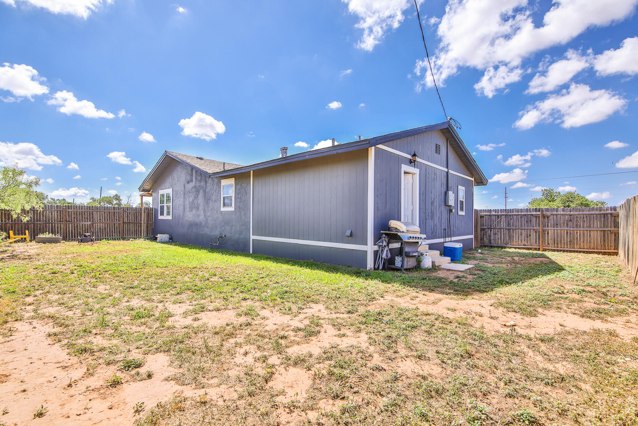 805 South 4th Street Slaton, TX 79364 - Photo 28 of 28 a view of a backyard with a large tree