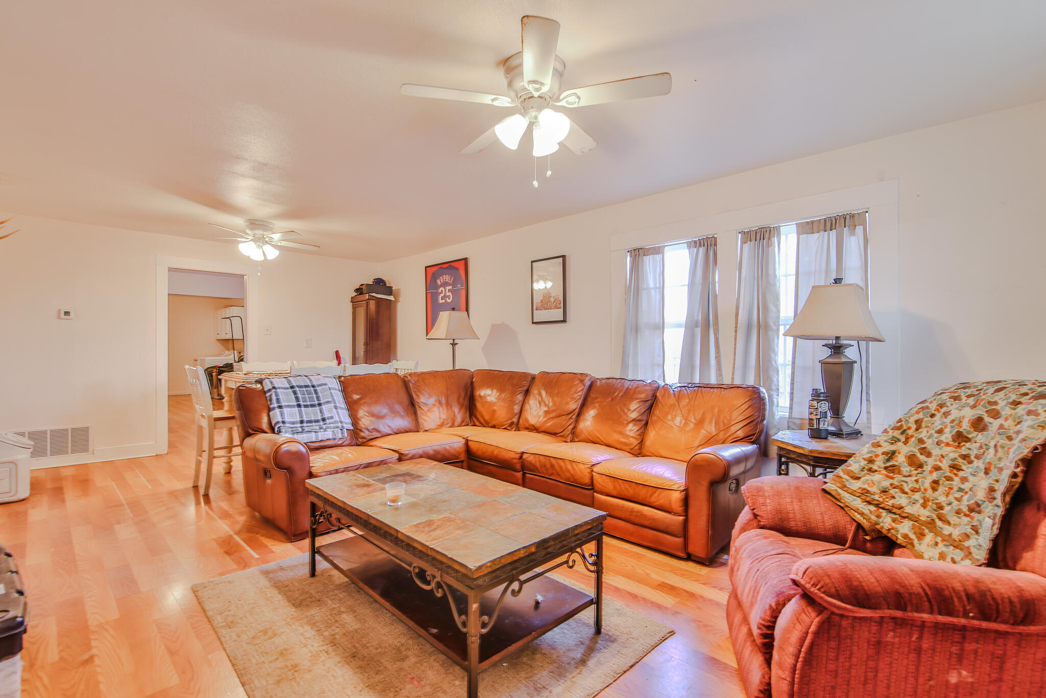 805 South 4th Street Slaton, TX 79364 - Photo 4 of 28 a living room with furniture and a chandelier