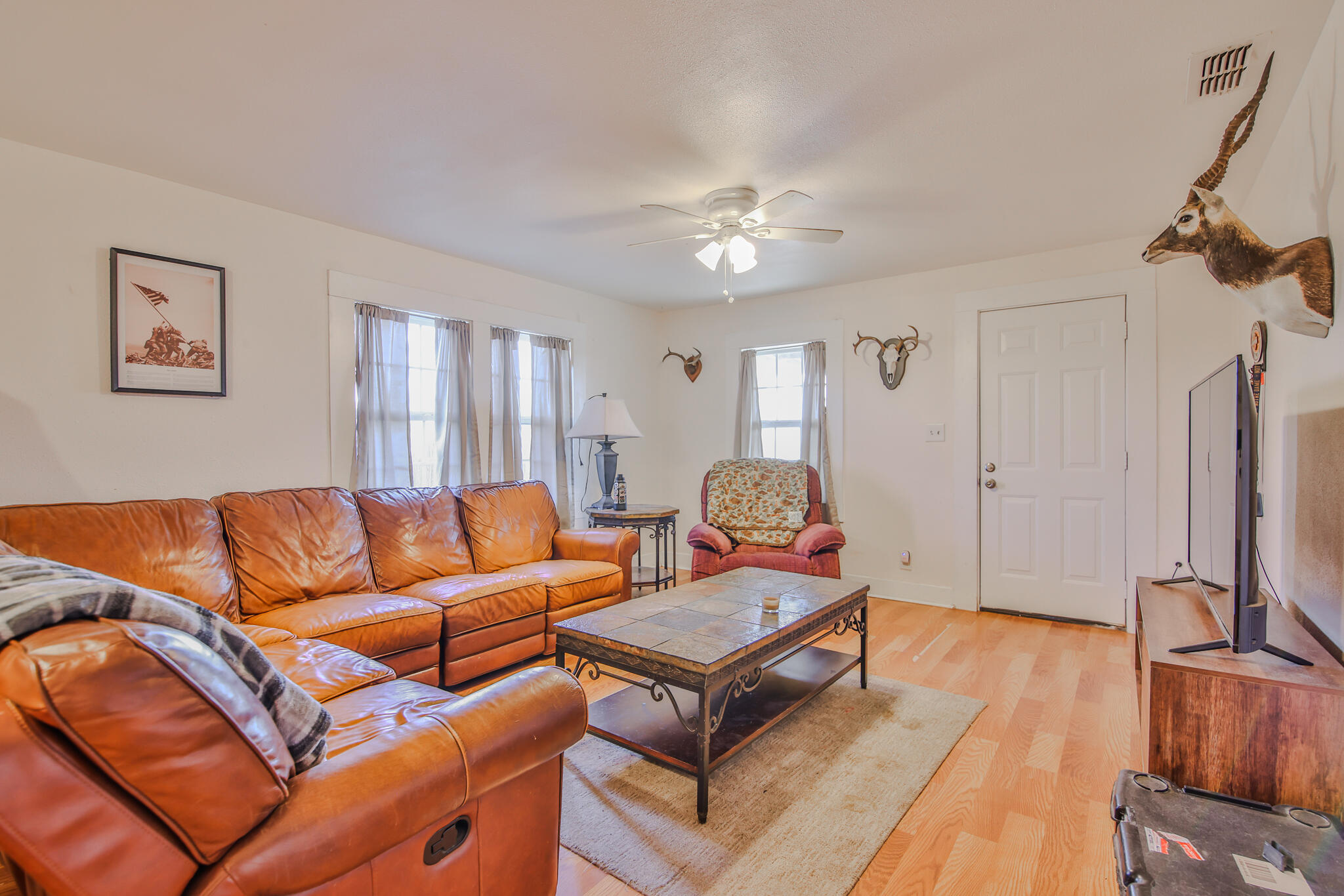 805 South 4th Street Slaton, TX 79364 - Photo 5 of 28 a living room with furniture a ceiling fan and a rug