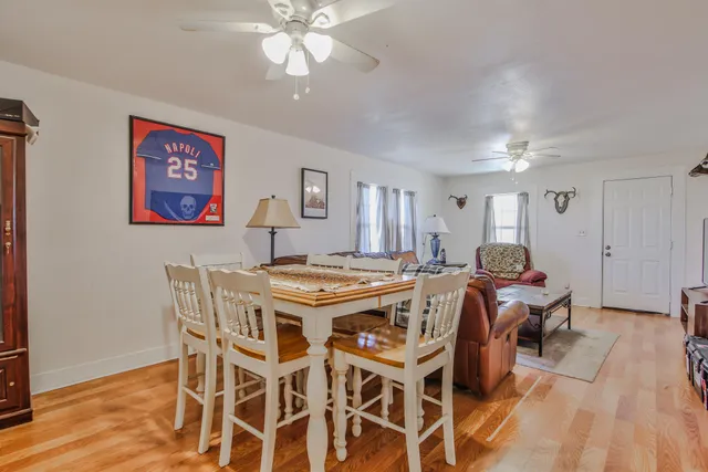 a view of a dining room with furniture and wooden floor