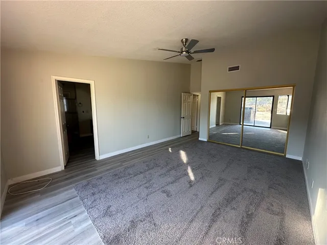 a view of a livingroom with a ceiling fan and window