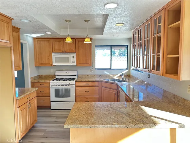 a kitchen with stainless steel appliances granite countertop a stove and a sink