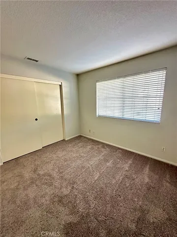 an empty room with a empty space and windows
