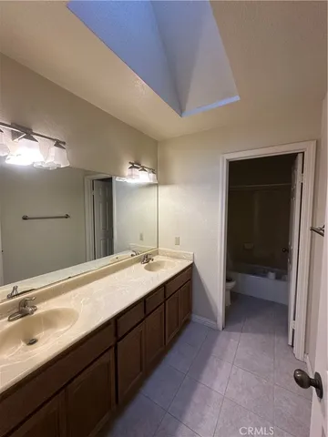 a bathroom with a double vanity sink and mirror