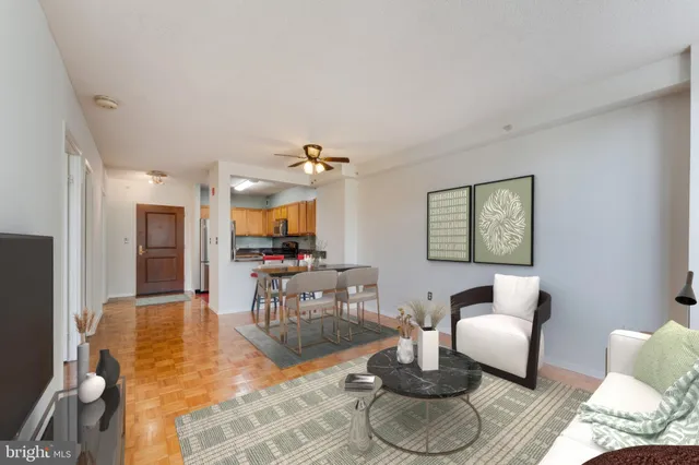 a living room with furniture and a dining table with wooden floor