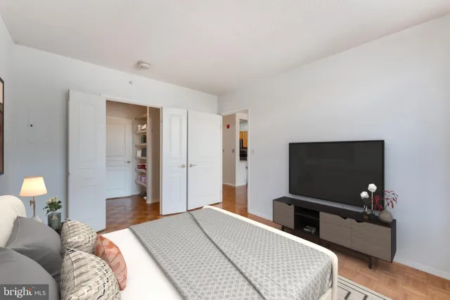 a bedroom with a bed and a flat screen tv