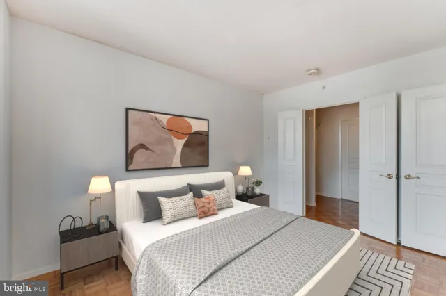 a bedroom with a bed and a painting on the wall