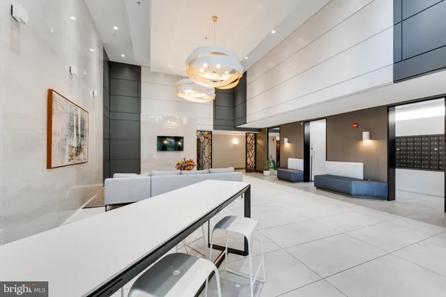 a large living room with stainless steel appliances furniture a fireplace and a projector