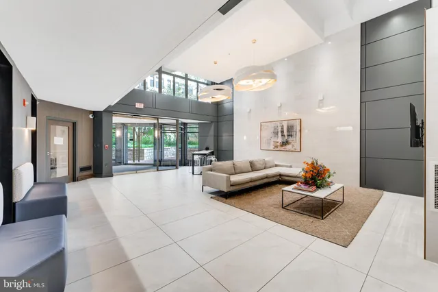 a living room with furniture and a chandelier