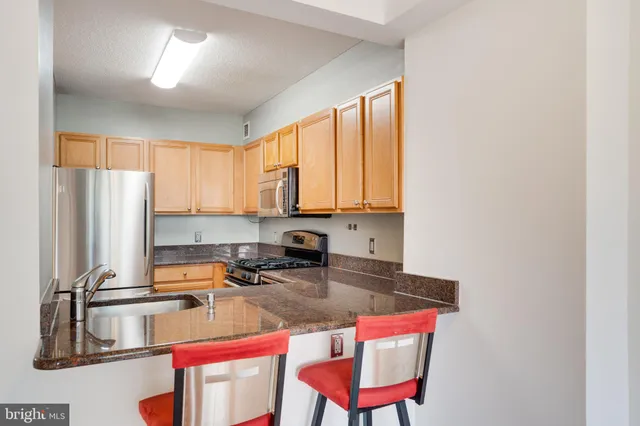 a kitchen with a stove a sink and a refrigerator