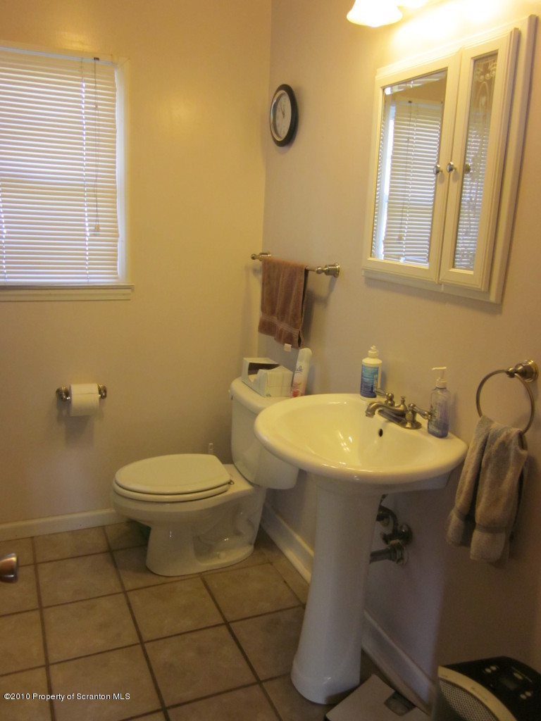 512 State Rte 92 South Tunkhannock, PA 18657 - Photo 4 of 8 a bathroom with a sink mirror and toilet
