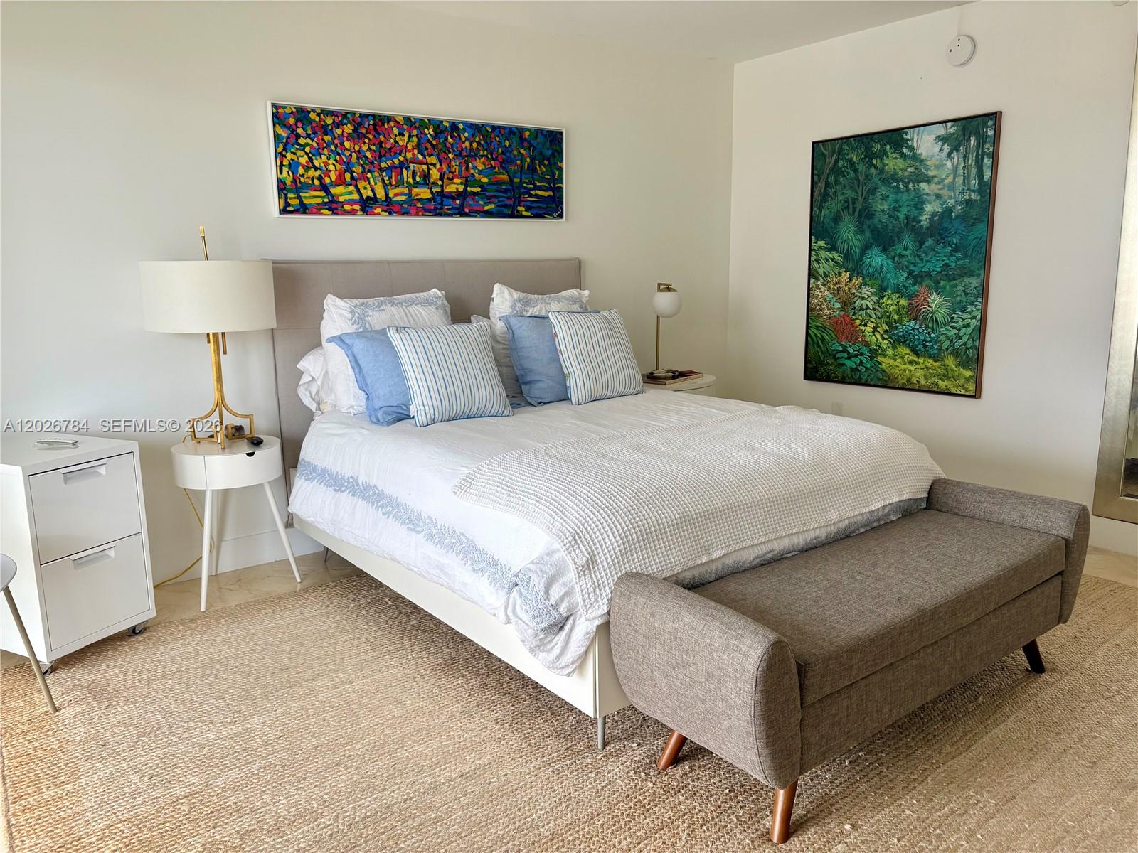 151 Southeast 15th Road, Unit 601 Miami, FL 33129 - Photo 18 of 36 a bed sitting in a bedroom next to a window