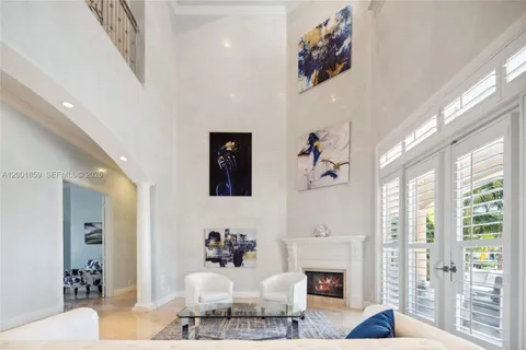 a living room with furniture a fireplace and a large window