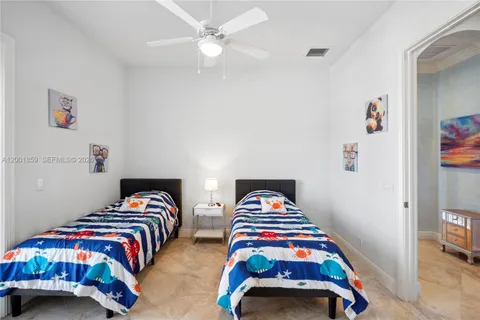 a bedroom with two beds and a couch