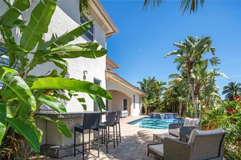 a view of backyard with outdoor seating and plants