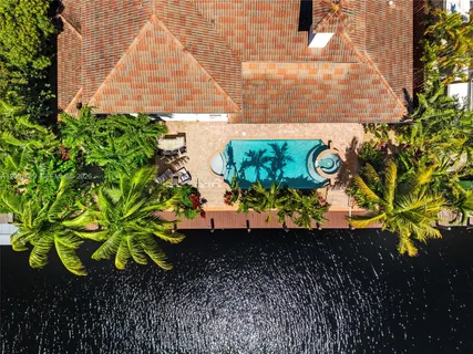 an aerial view of residential houses with outdoor space and street view