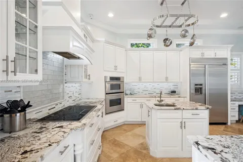 a kitchen with a sink stove and refrigerator