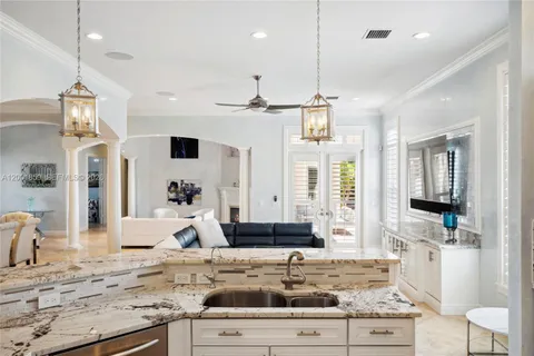 a living room with stainless steel appliances kitchen island granite countertop furniture and a view of living room
