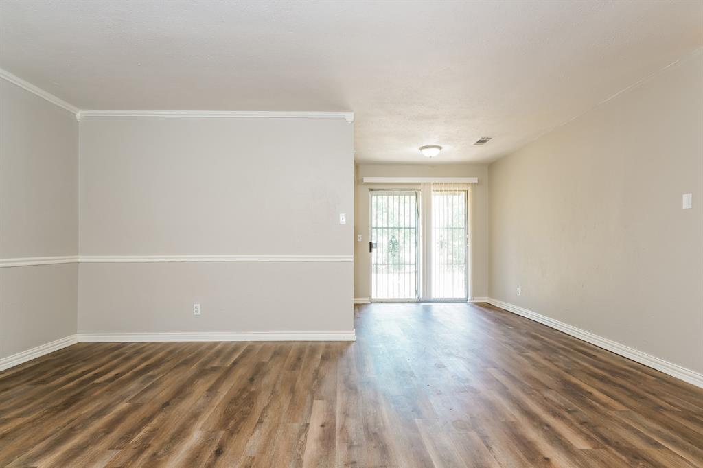 6530 Gentle River Drive Dallas, TX 75241 - Photo 3 of 15 an empty room with wooden floor and windows