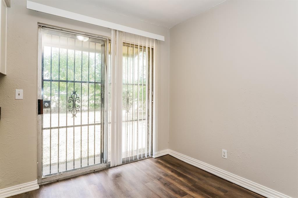 6530 Gentle River Drive Dallas, TX 75241 - Photo 5 of 15 a view of an empty room with wooden floor and a window