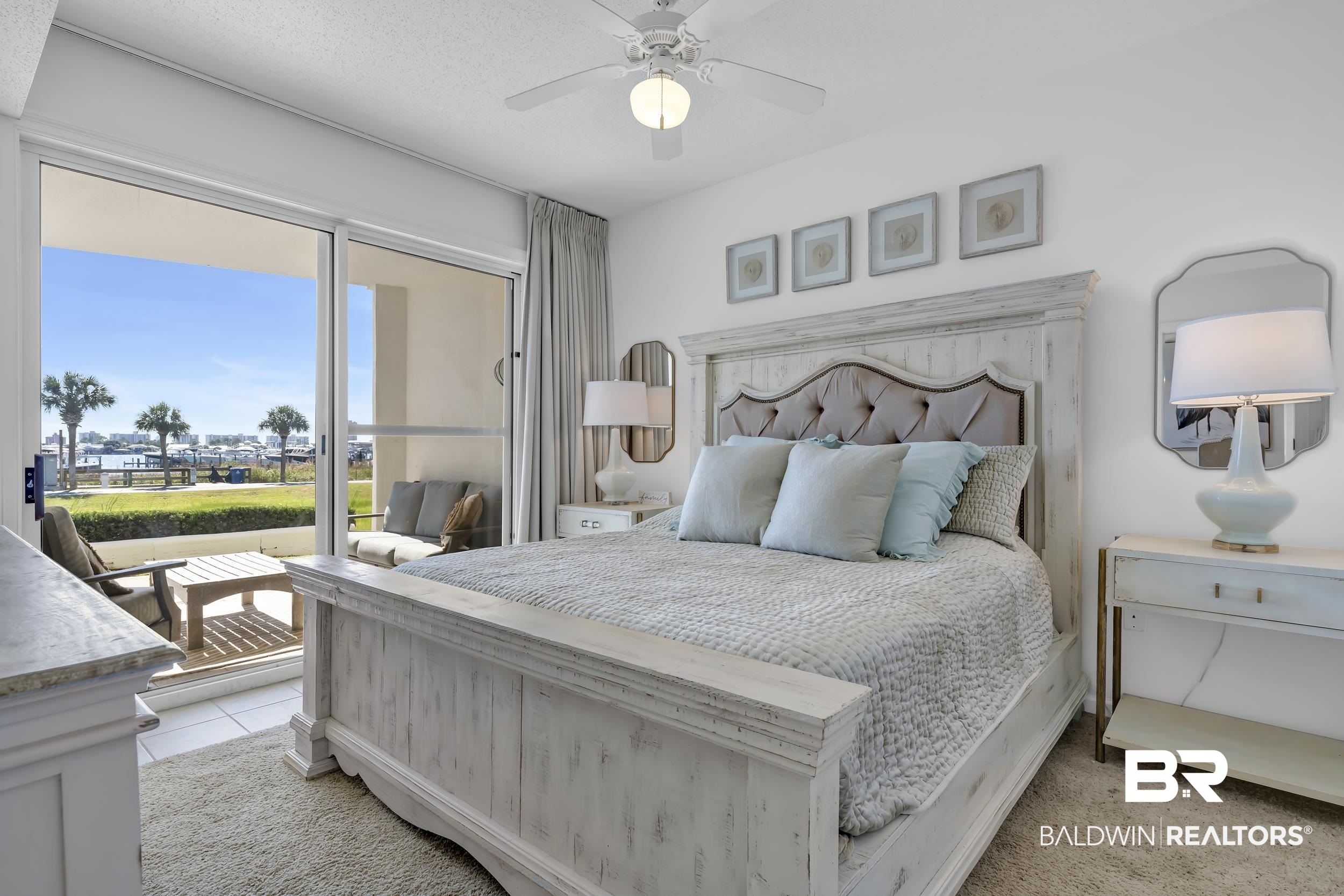 27282 Canal Road, Unit 104 Orange Beach, AL 36561 - Photo 31 of 79 Bedroom featuring a ceiling fan, access to exterior, light tile patterned floors, and light colored carpet