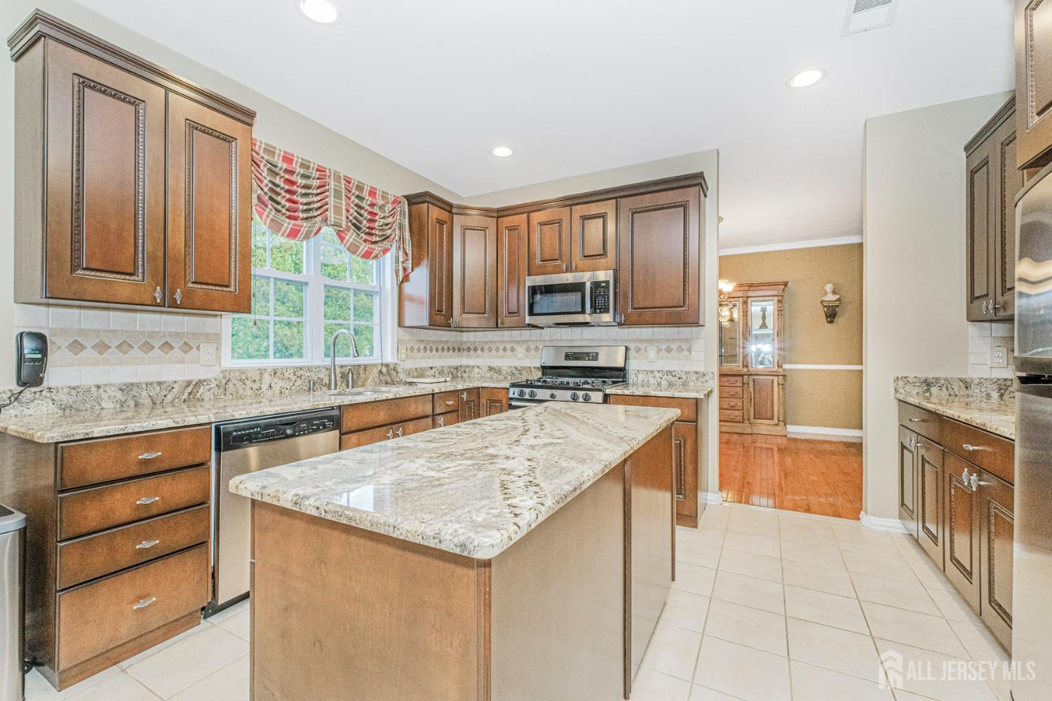 19 Helene Street Old Bridge, NJ 08857 - Photo 15 of 46 a kitchen with granite countertop a sink stove and refrigerator