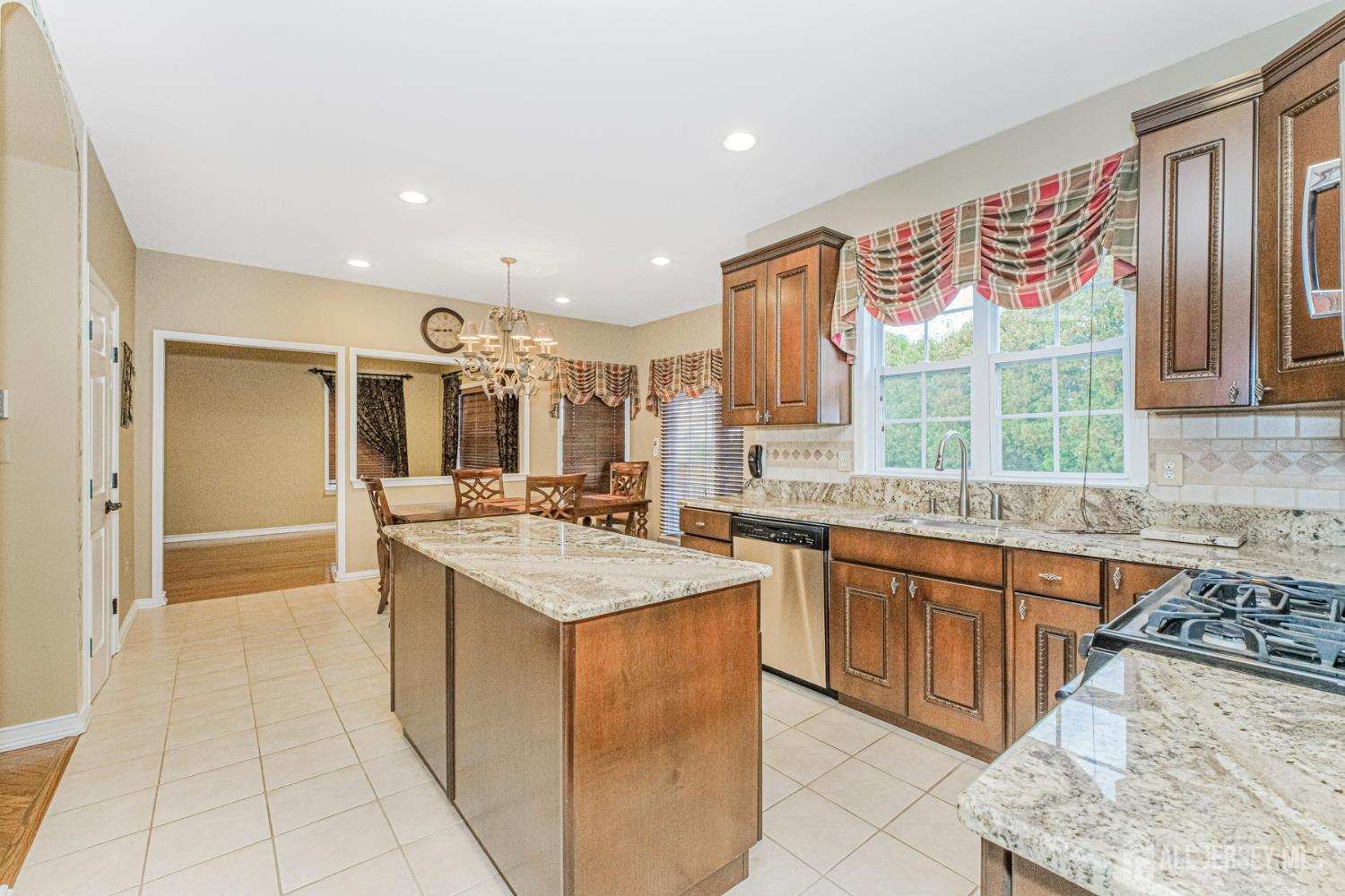 19 Helene Street Old Bridge, NJ 08857 - Photo 16 of 46 a kitchen with stainless steel appliances granite countertop a sink and a stove