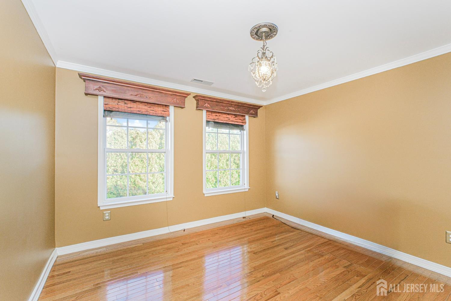 19 Helene Street Old Bridge, NJ 08857 - Photo 31 of 46 a view of an empty room with wooden floor and a window
