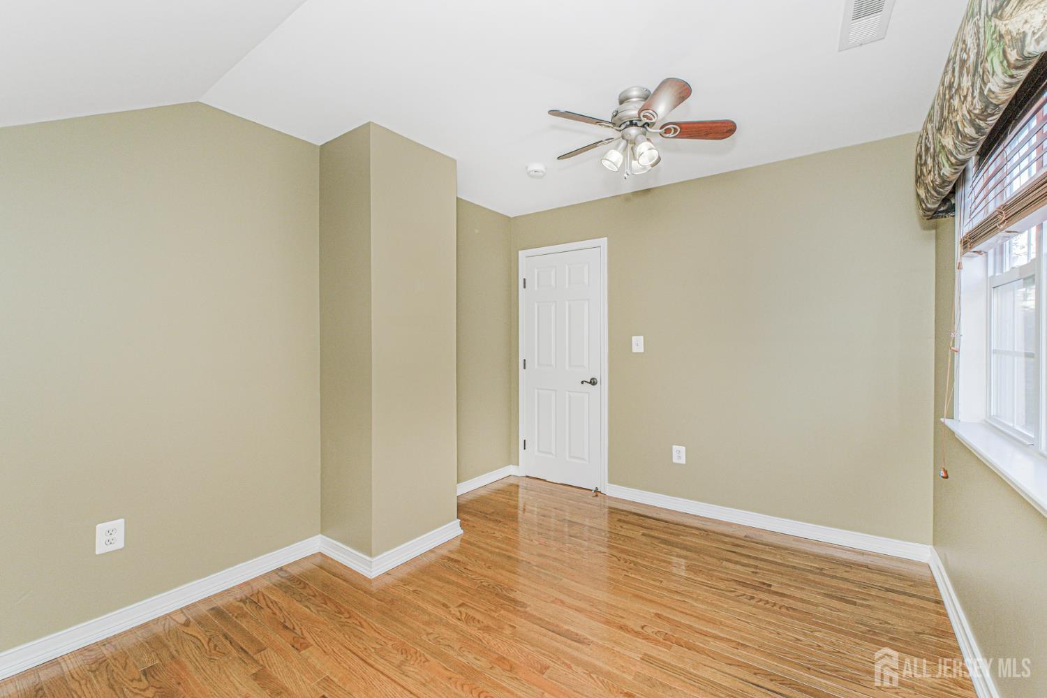 19 Helene Street Old Bridge, NJ 08857 - Photo 32 of 46 a view of an empty room with wooden floor and a window