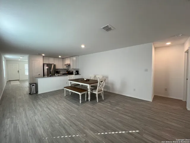 a kitchen with a table and chairs
